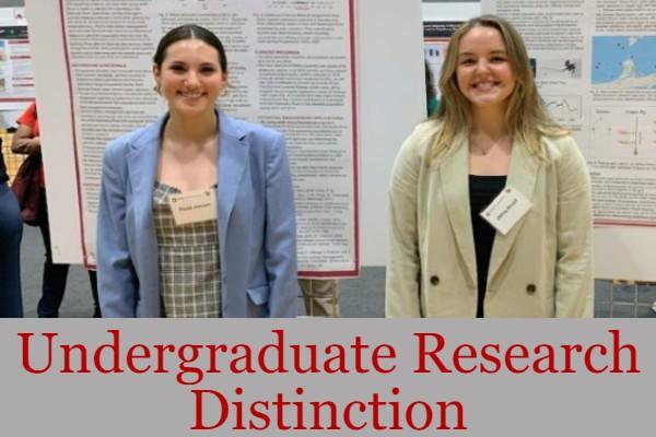 Paula Joseph and Olivia Houpt in front of their posters; text: Undergraduate Research Distinction